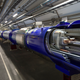 A diagram of the LHC superimposed on a photo of its beamline